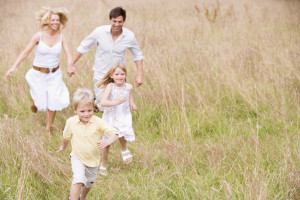 Family running outdoors smiling